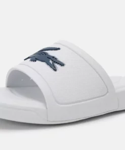 Lacoste SLIDE UNISEX - Sandales De Bain - White/dark Blue -Lacoste Soldes Magasin 7ddf0fac4d134ea7967a965c34eba304
